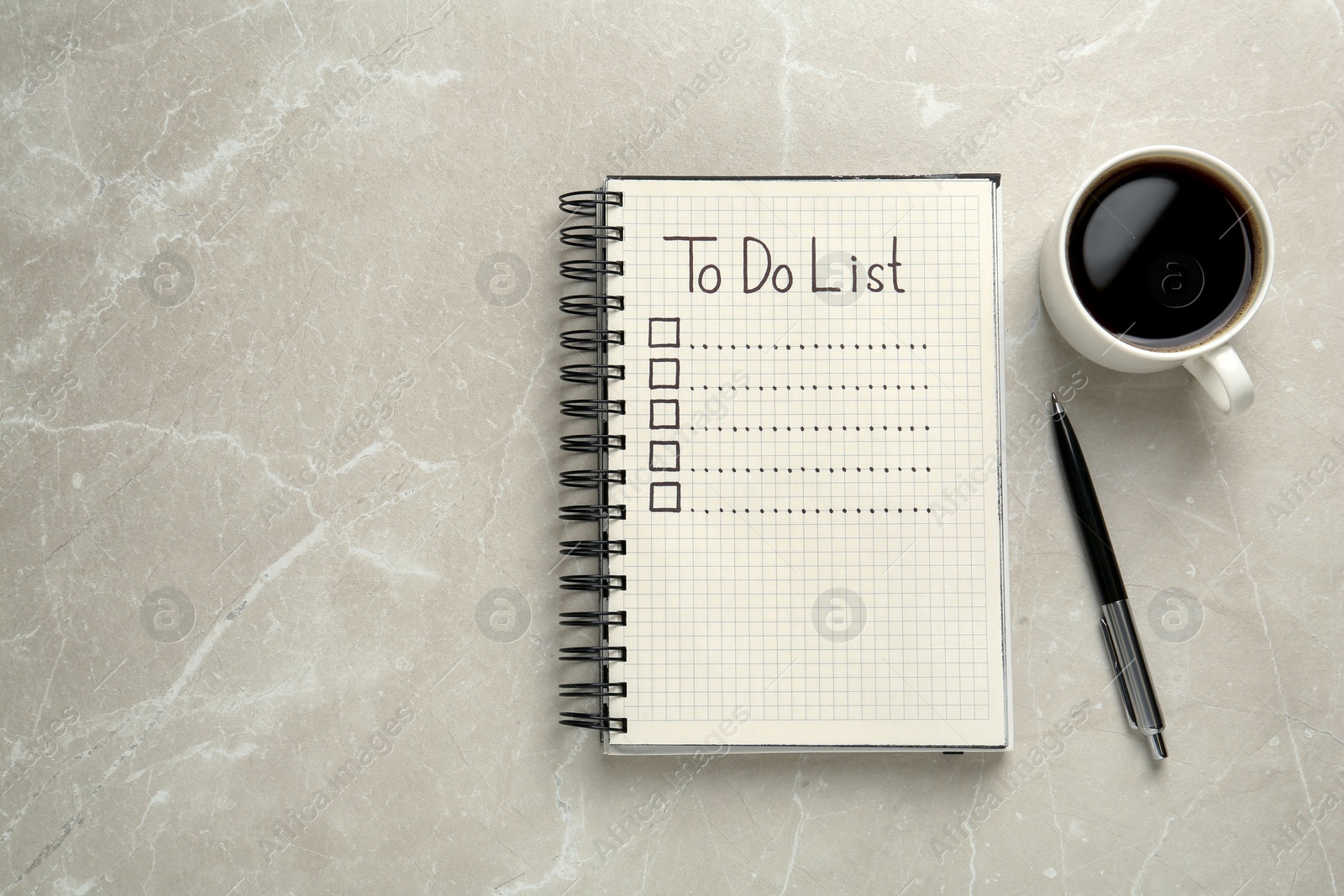 Photo of Notepad with unfilled To Do list, pen and cup of coffee on light grey marble table, flat lay. Space for text