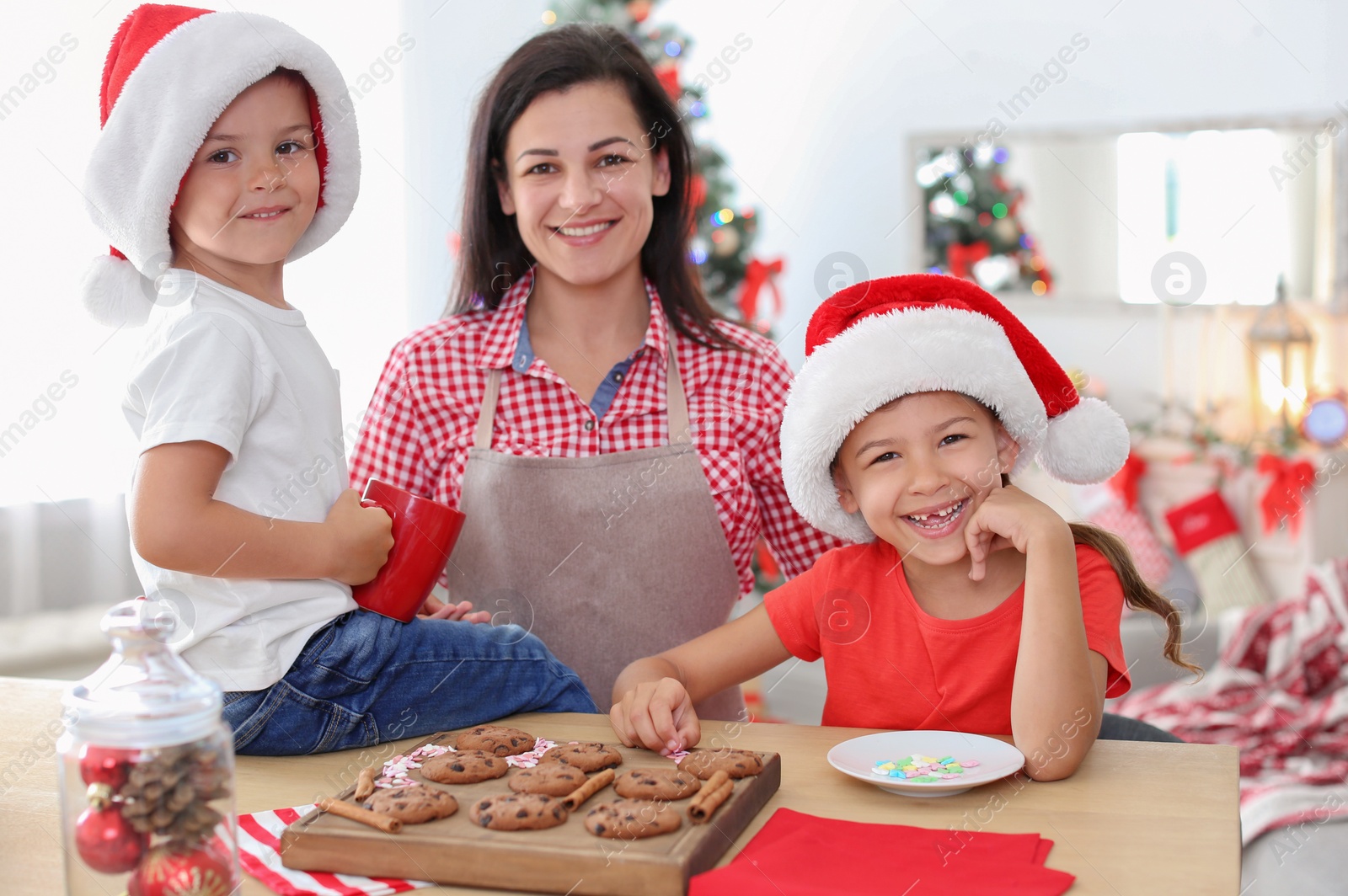 Photo of Mother and children making Christmas cookies together at home