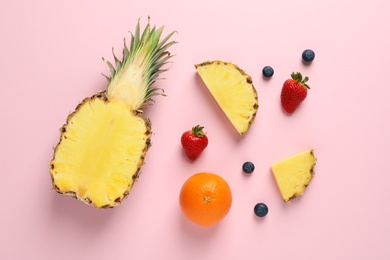 Flat lay composition with fresh fruits and berries on color background