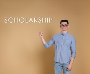 Image of Scholarship concept. Portraithappy student on beige background