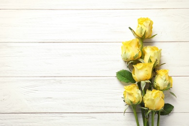 Photo of Flat lay composition with beautiful blooming flowers on wooden background