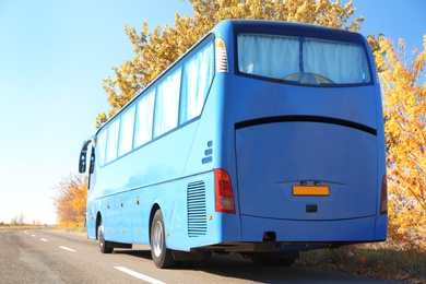 Photo of Modern blue bus on road. Passenger transportation