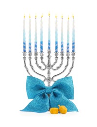 Hanukkah celebration. Menorah with colorful candles, bow and dreidels isolated on white