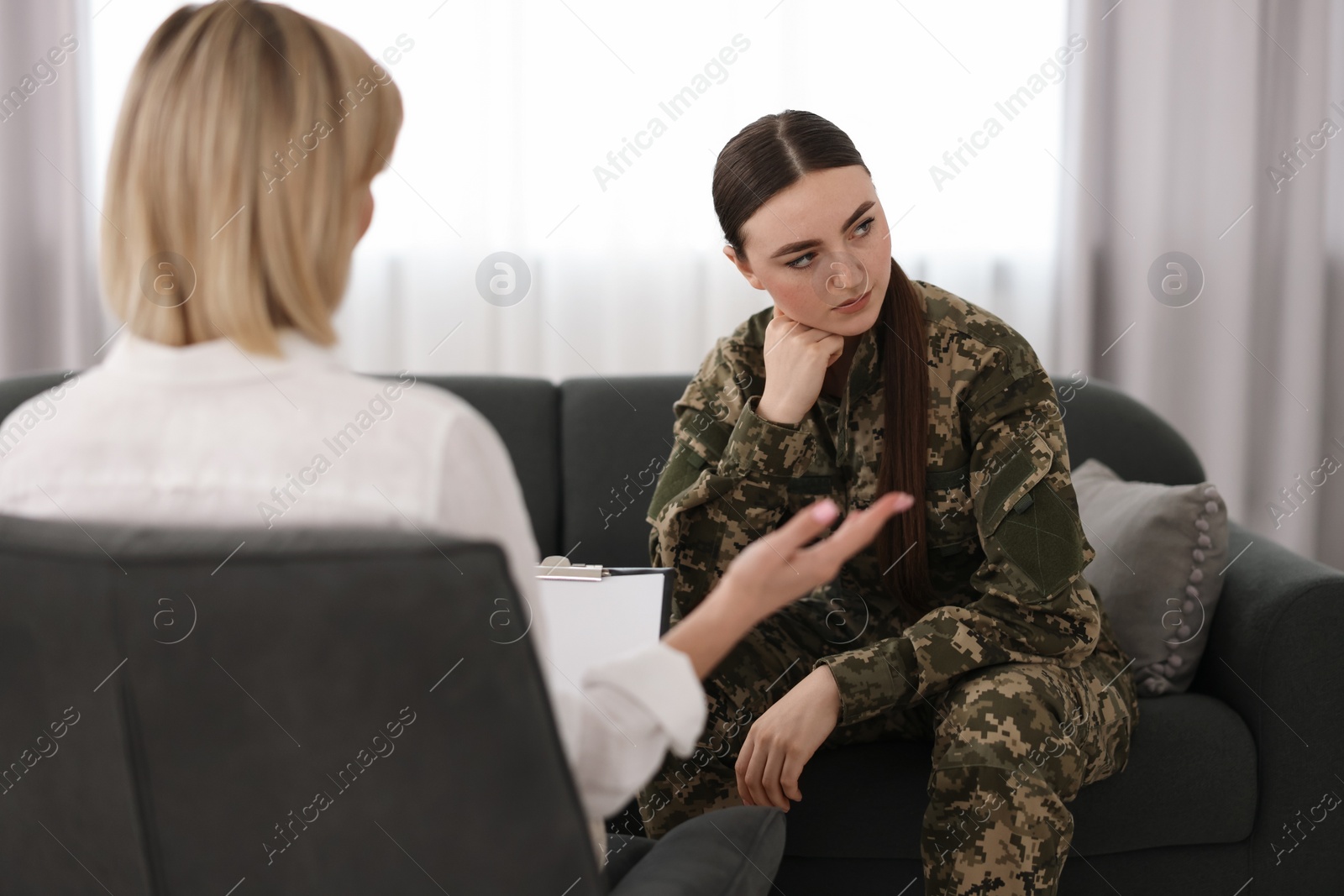 Photo of Psychotherapist working with military woman in office