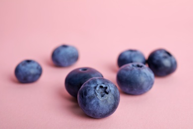 Tasty ripe blueberry on color background, closeup