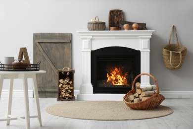 Photo of Cozy living room interior with firewood and white fireplace
