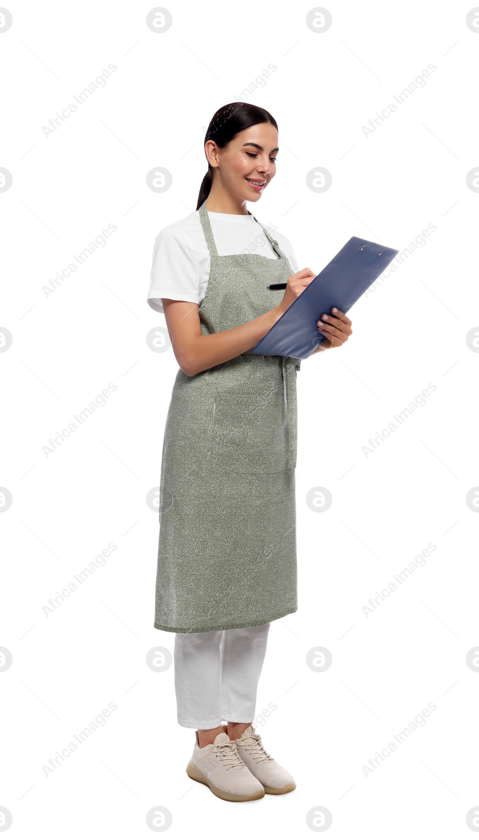 Photo of Young woman in light green apron with clipboard on white background