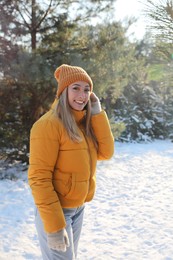 Young woman enjoying winter day in forest