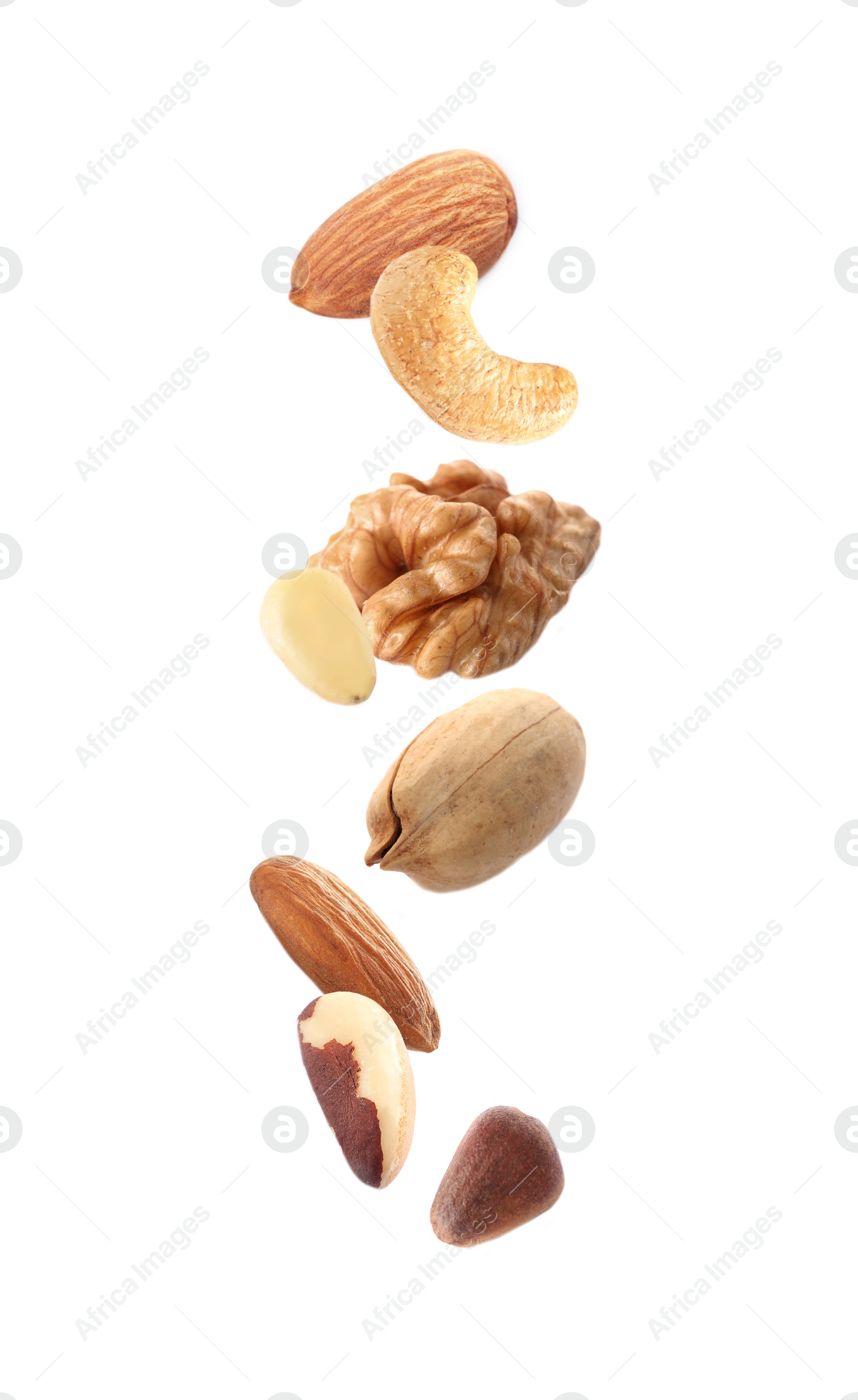 Image of Different nuts falling on white background 