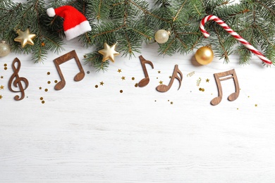 Flat lay composition with decorations and  notes on wooden background. Christmas music concept