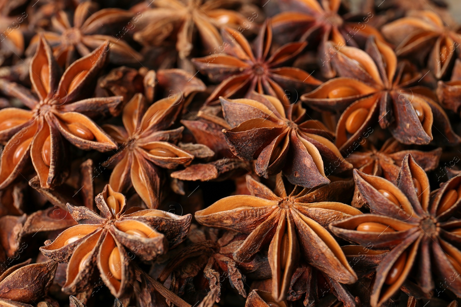 Photo of Aromatic anise stars as background, closeup view