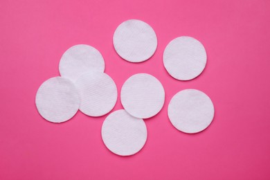 Photo of Many clean cotton pads on pink background, flat lay