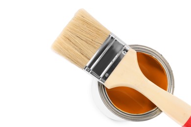Photo of Can of orange paint and brush on white background, top view