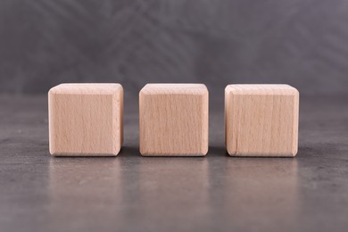 Photo of Wooden cubes with abbreviation ISO on grey textured table