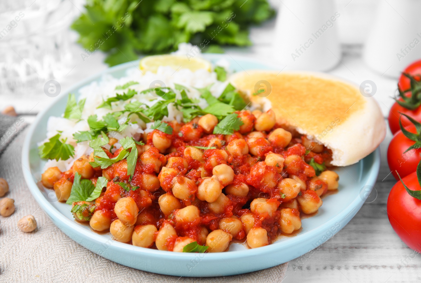 Photo of Plate with delicious chickpea curry on table, closeup