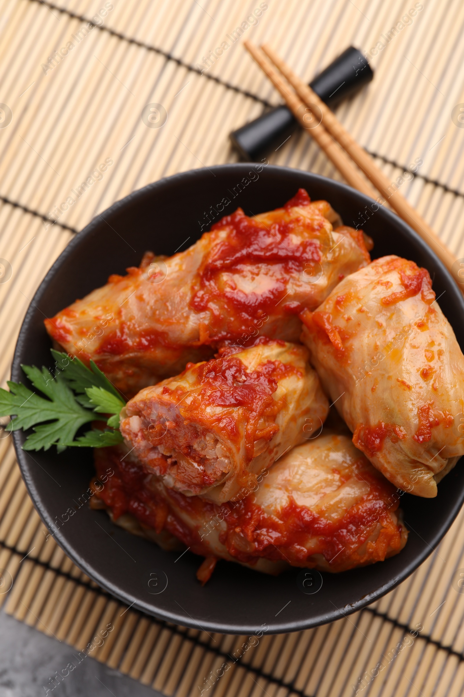 Photo of Delicious stuffed cabbage rolls cooked with homemade tomato sauce on table, top view