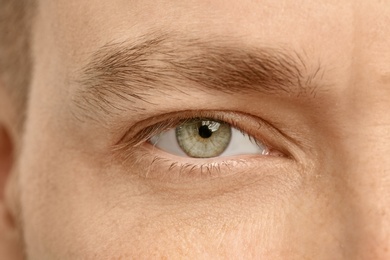 Photo of Young man, closeup of eye. Visiting ophthalmologist