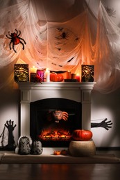 Photo of Room with fireplace decorated for Halloween. Festive interior