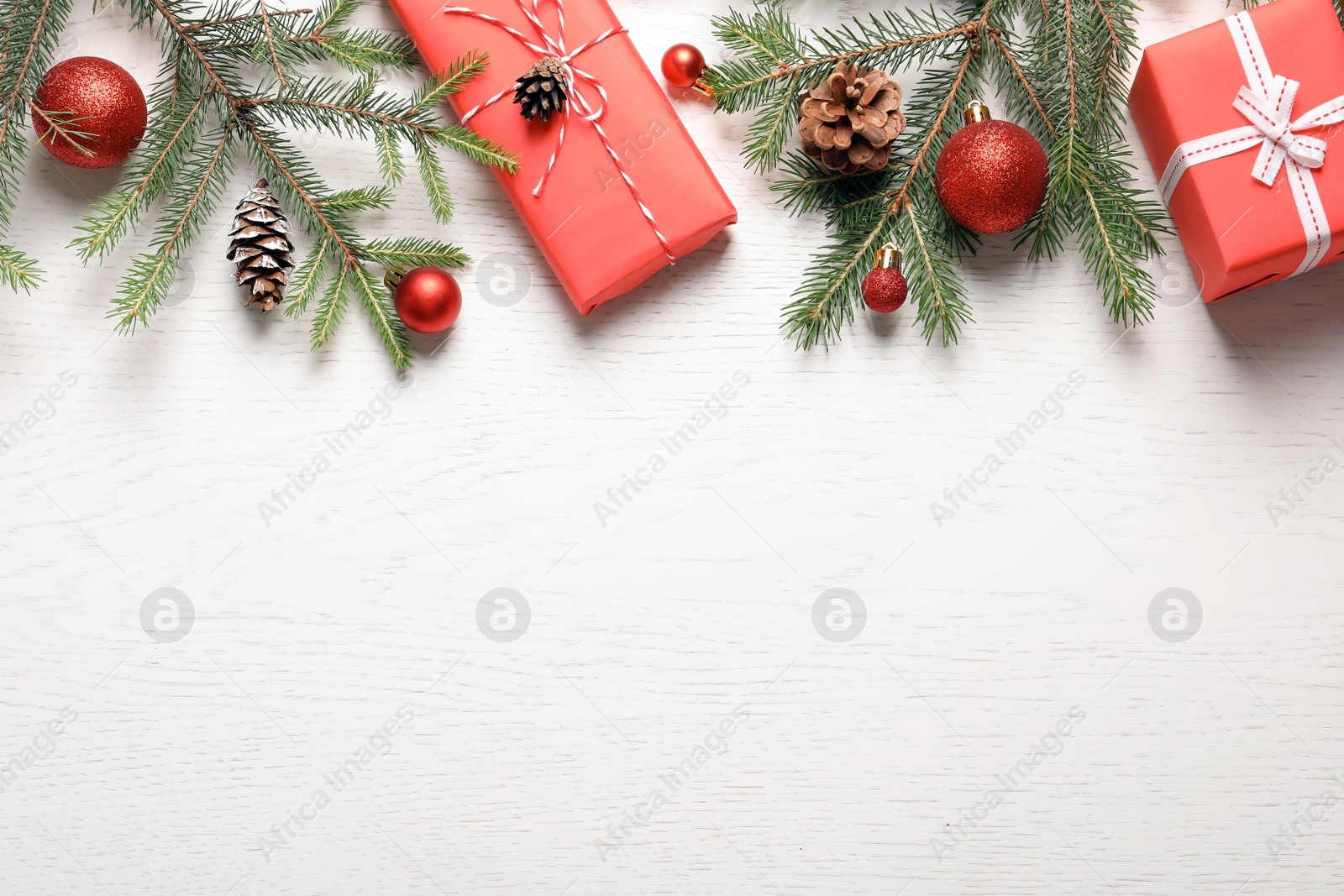 Photo of Flat lay composition with Christmas gifts and fir branches on light background