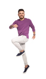Photo of Handsome young man jumping on white background