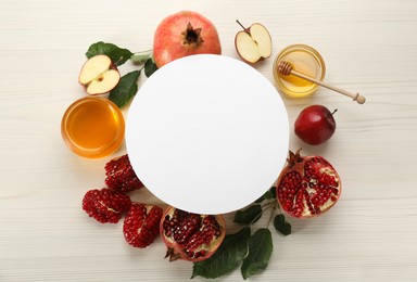 Photo of Flat lay composition with Rosh Hashanah holiday attributes and card on white wooden table. Space for text