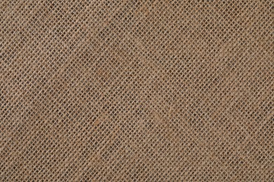 Brown burlap fabric as background, top view