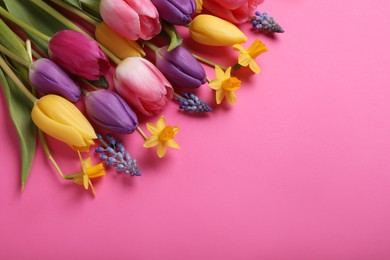 Beautiful different flowers on pink background, flat lay. Space for text