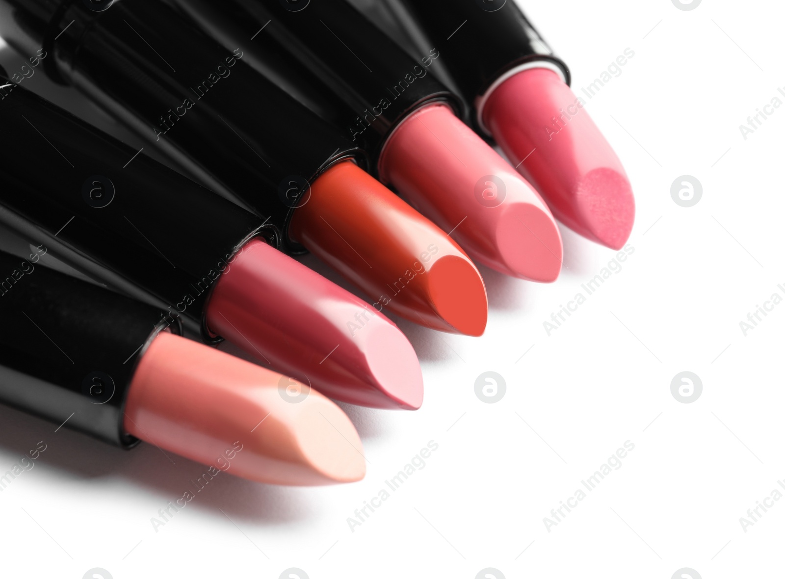 Photo of Different lipsticks on white background. Cosmetic product