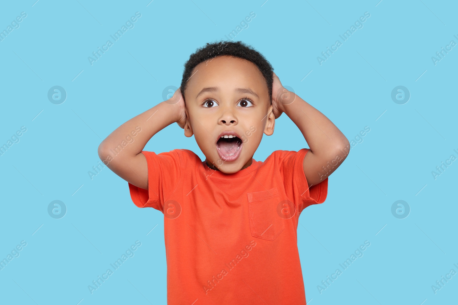 Photo of Portrait of emotional African-American boy on turquoise background