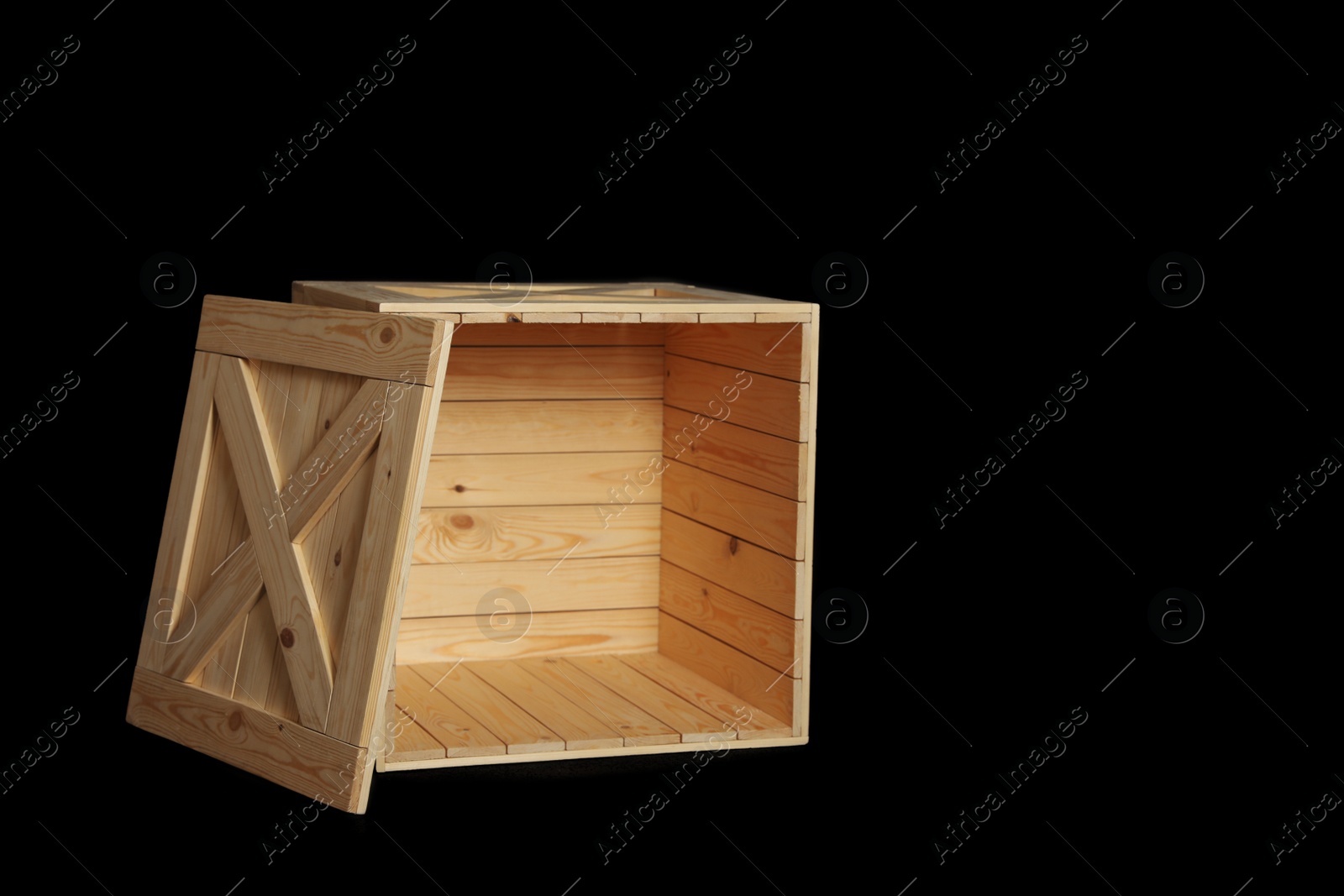 Photo of Wooden crate on black background. Space for text