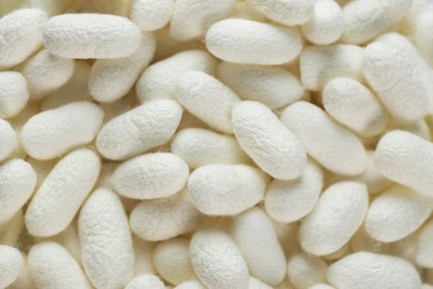 Photo of Pile of natural silkworm cocoons as background, closeup