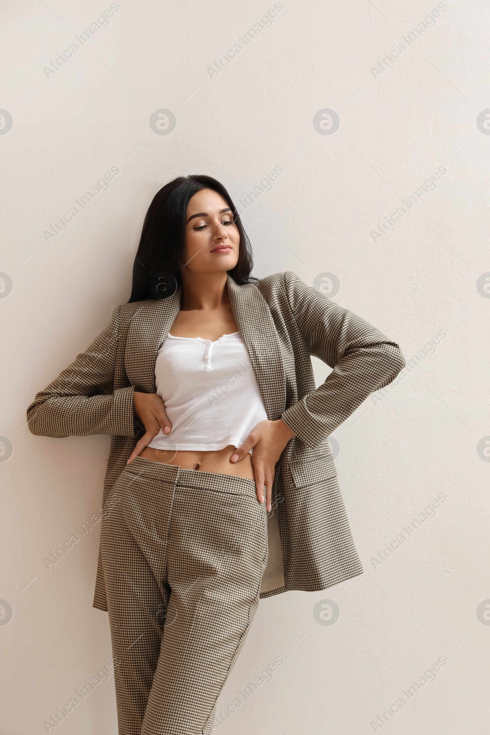 Photo of Beautiful woman in formal suit on light background. Business attire