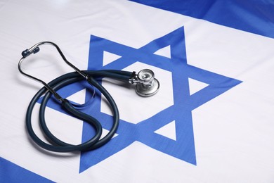 Photo of Stethoscope on flag of Israel. Health care concept