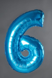 Photo of Blue number six balloon on grey background
