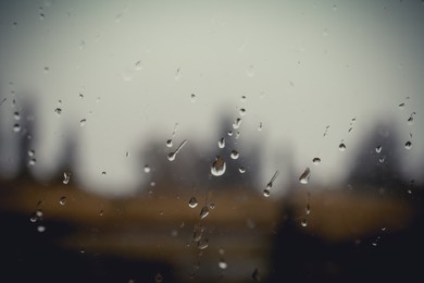 Photo of Blurred view through wet window on rainy day