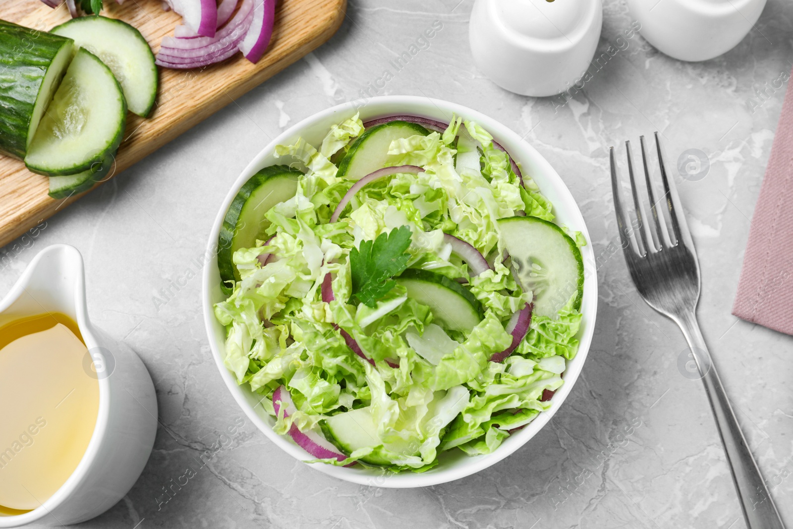 Photo of Flat lay composition with cabbage salad on light grey marble table