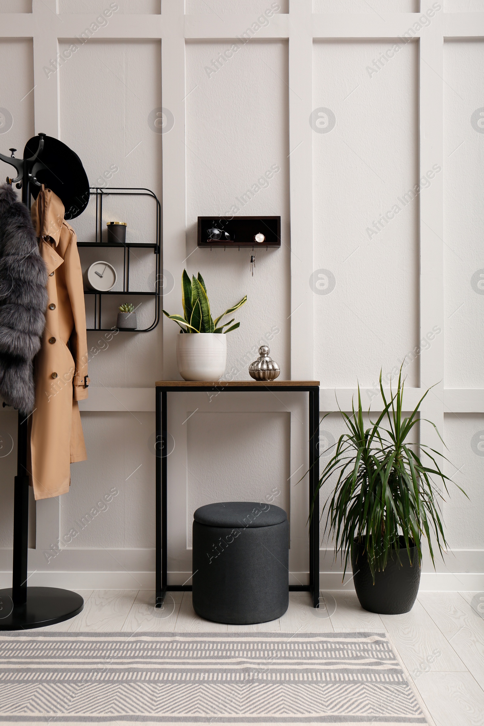 Photo of Stylish hanger for keys on white wall in hallway