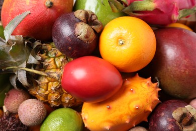 Photo of Different delicious exotic fruits as background, top view