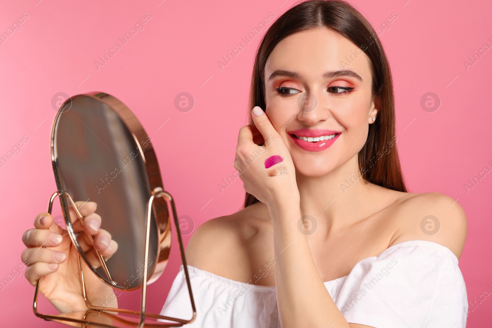 Photo of Beauty blogger with mirror on pink background