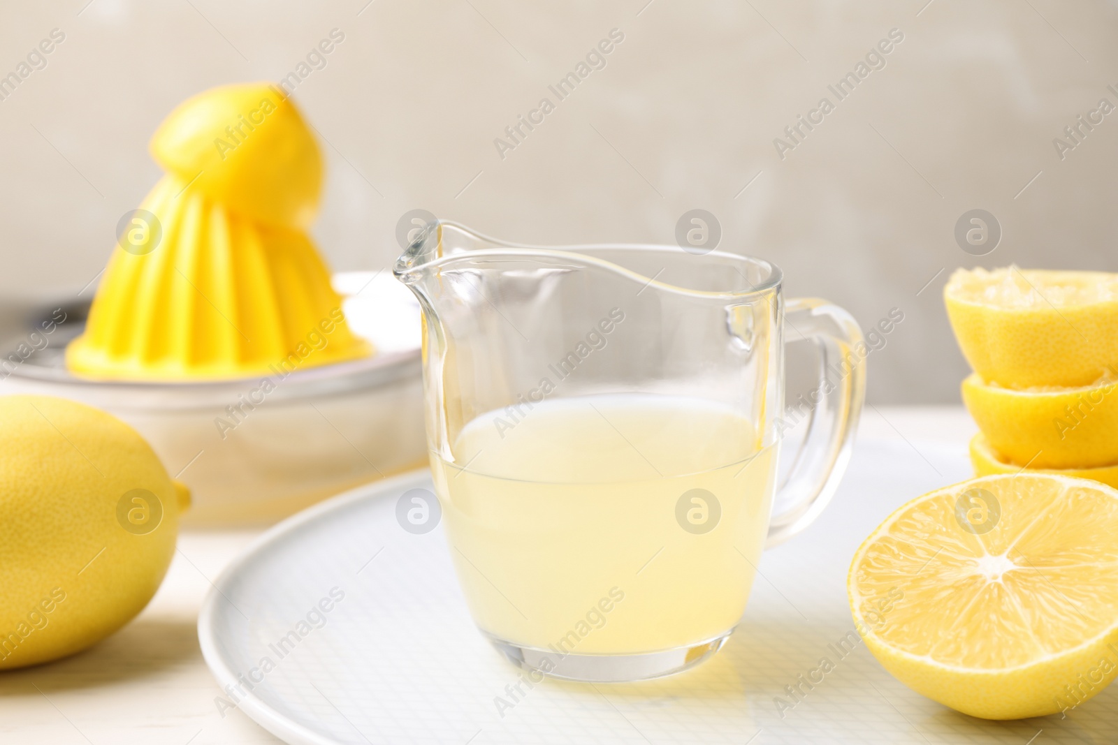 Photo of Freshly squeezed lemon juice on light table