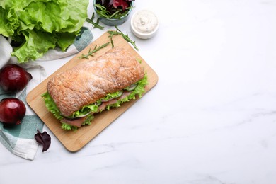Photo of Delicious sandwich with salmon and ingredients on white table, flat lay. Space for text