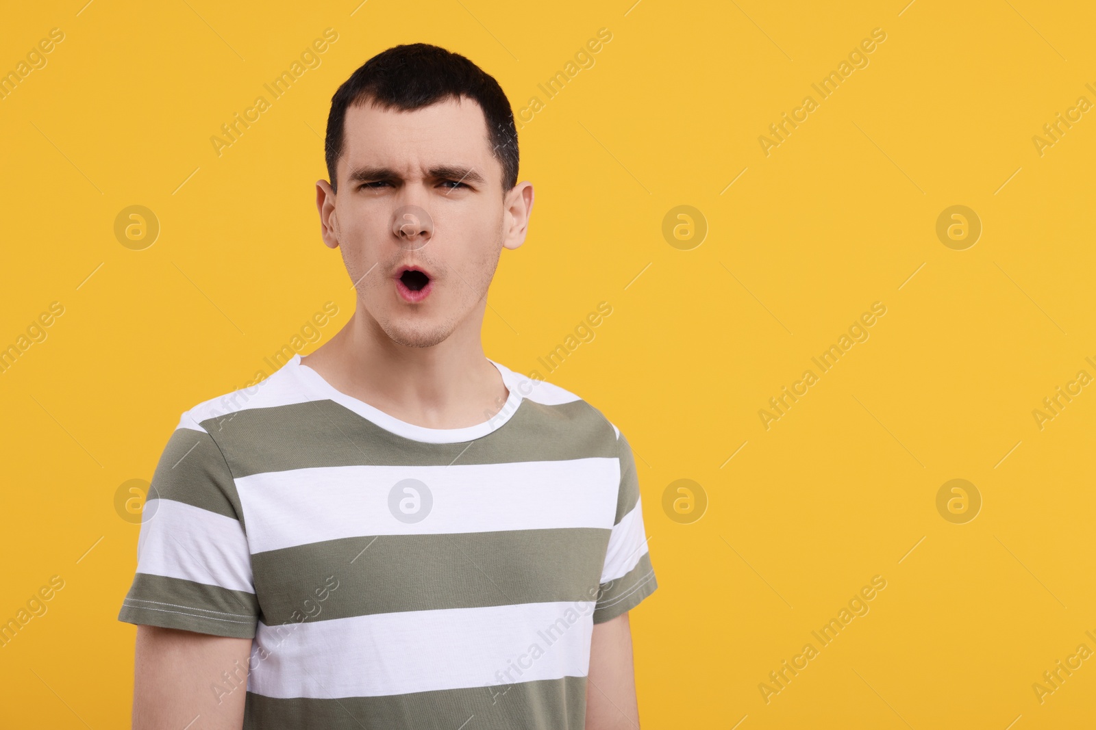 Photo of Portrait of surprised man on orange background, space for text