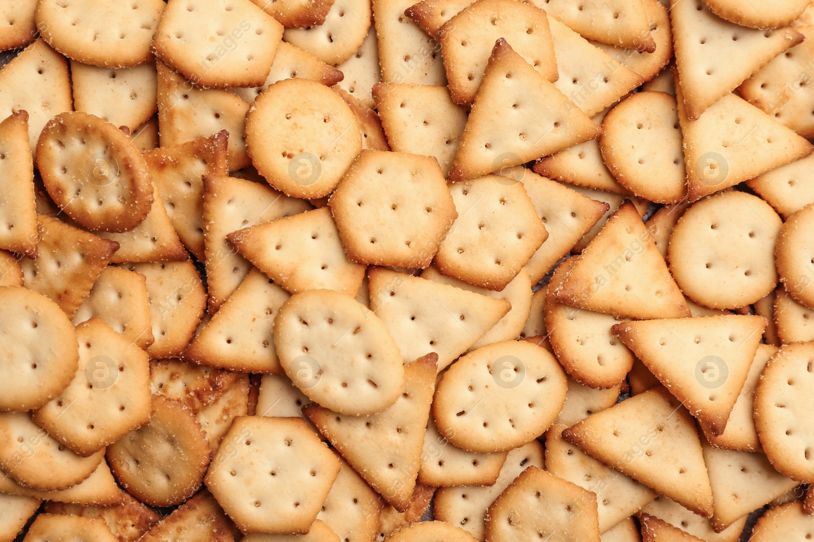 Photo of Many delicious crackers as background, top view