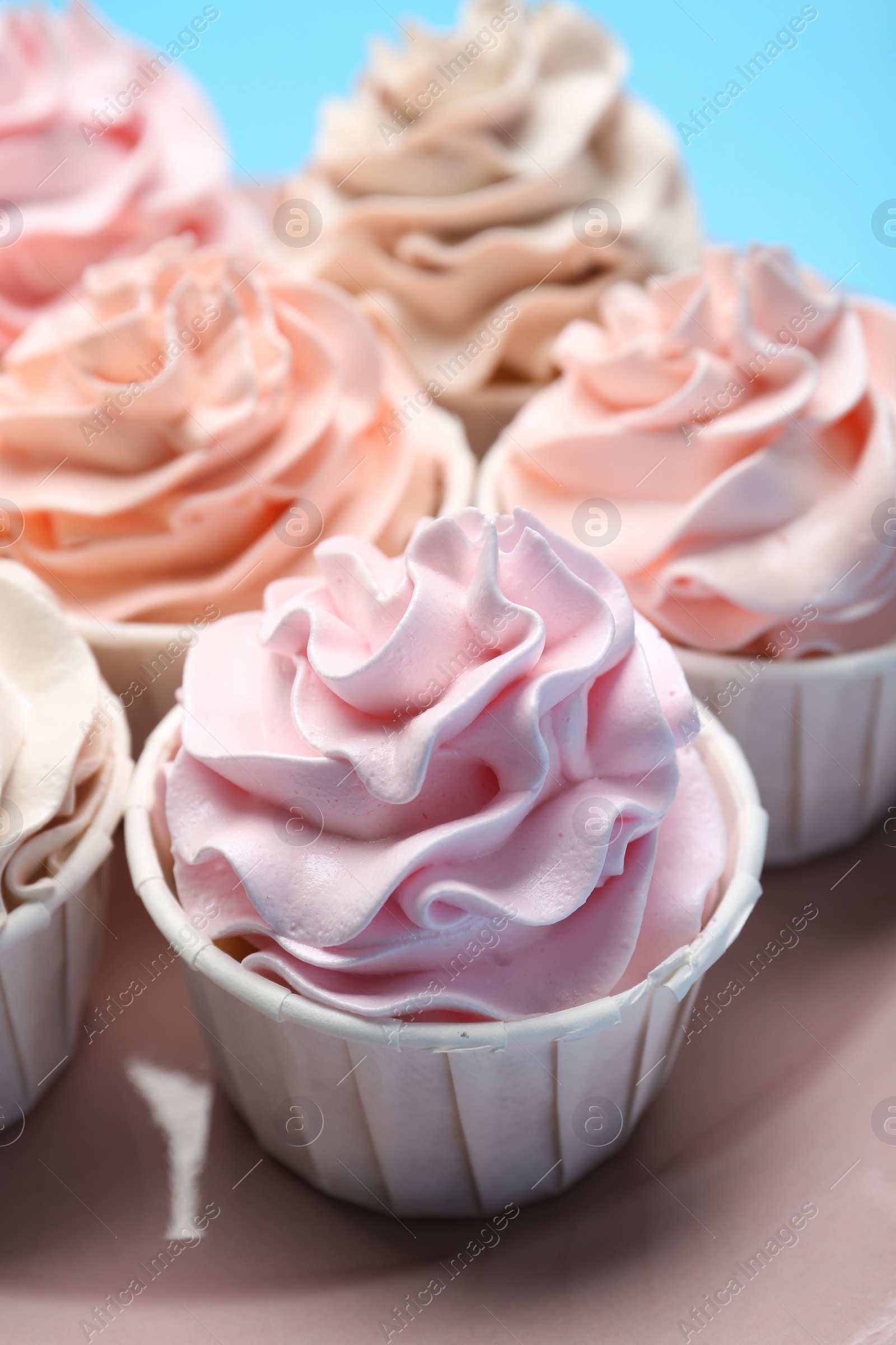 Photo of Many tasty cupcakes with cream on plate, closeup