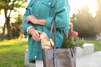 Photo of Woman with leather shopper bag in park, closeup