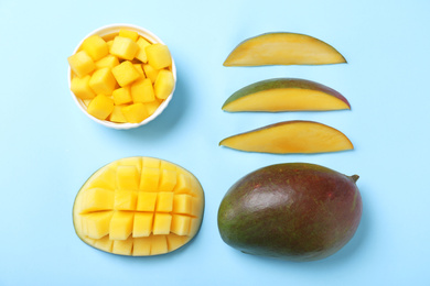 Flat lay composition with fresh ripe mango on light blue background