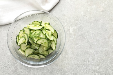 Photo of Delicious cucumber salad with dill in bowl on grey background, top view. Space for text