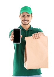 Photo of Young man holding paper bag and smartphone isolated on white, mockup for design. Online food delivery