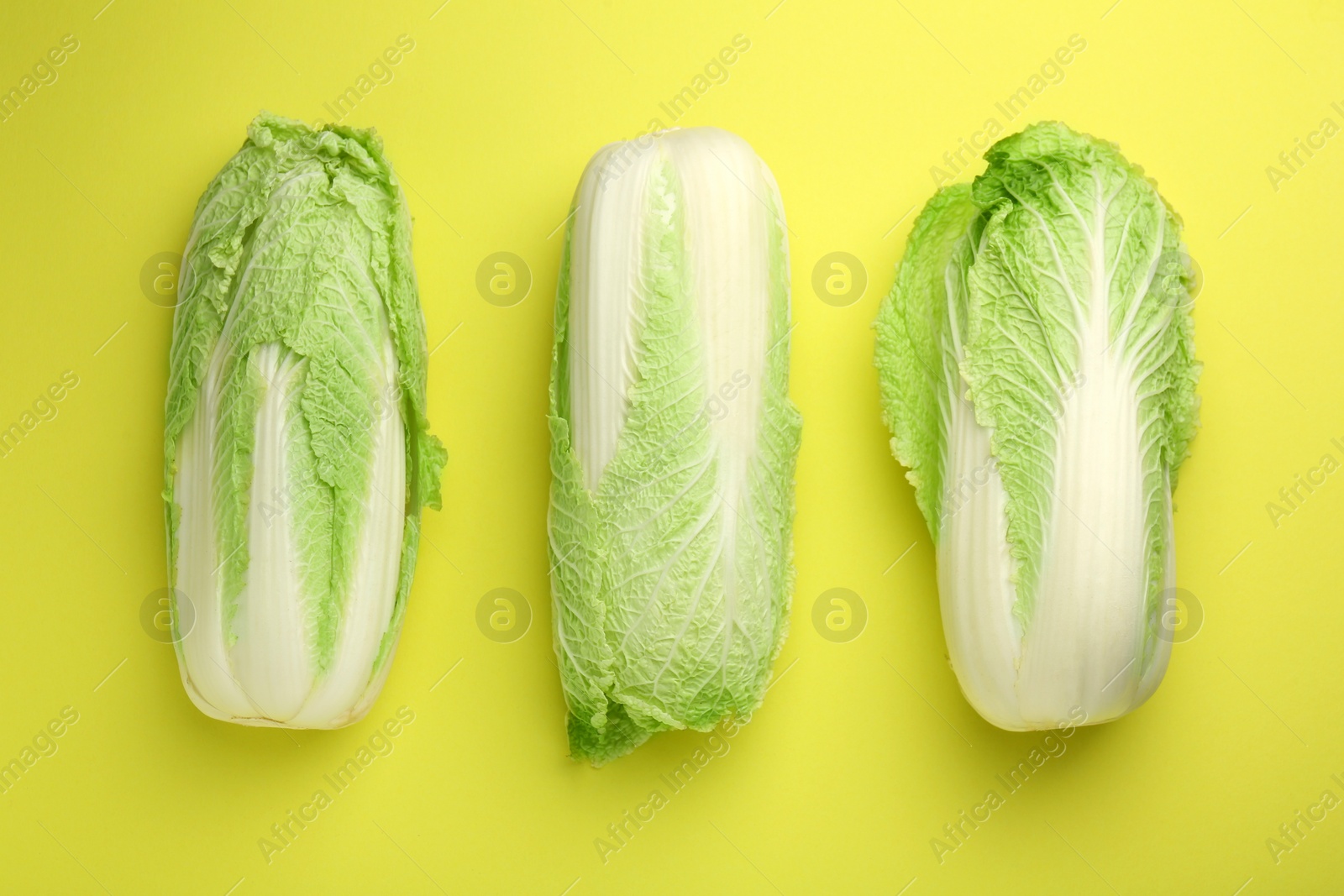 Photo of Fresh ripe Chinese cabbages on green background, top view