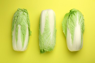 Photo of Fresh ripe Chinese cabbages on green background, top view